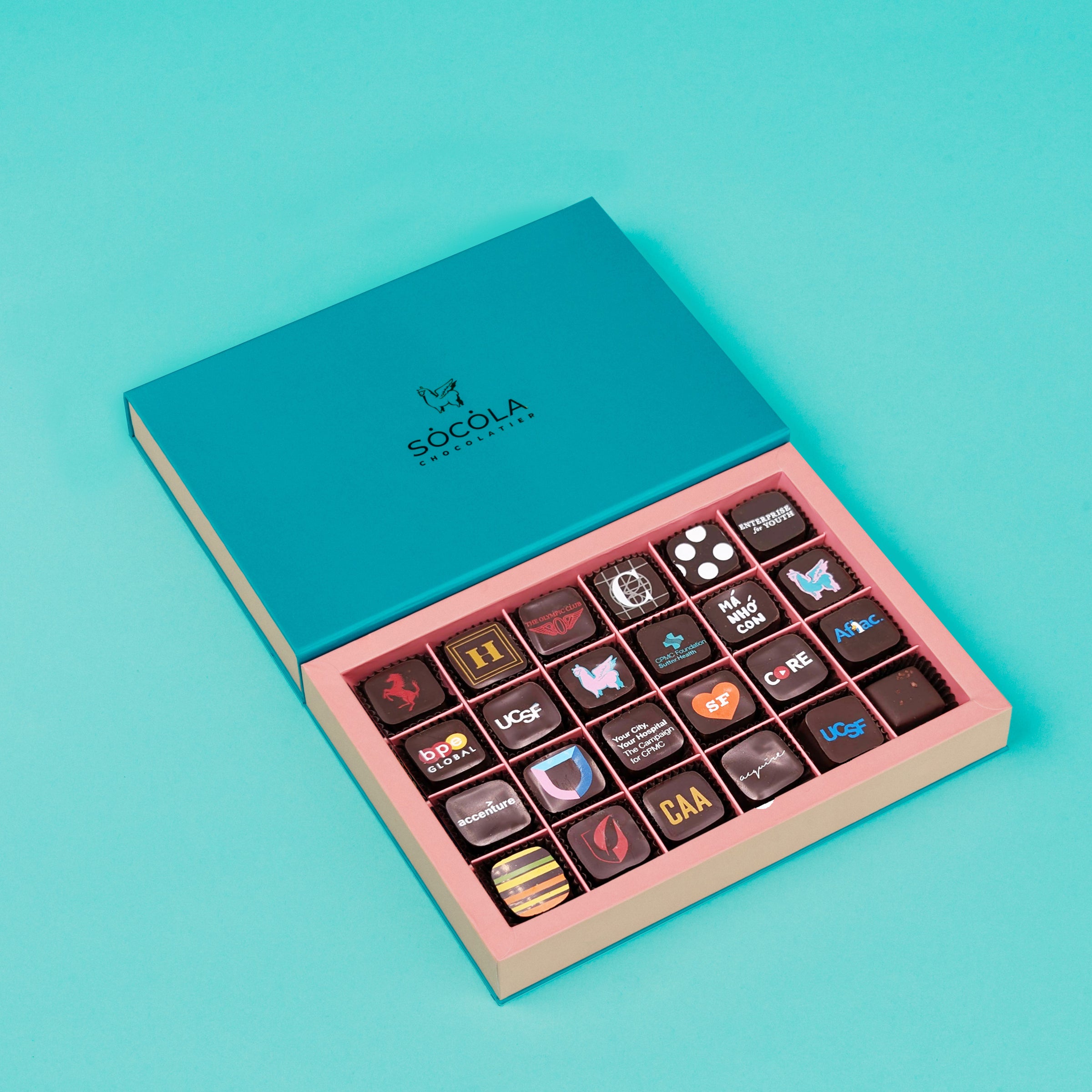 Custom printed artisan chocolates arranged on slate with colorful San Francisco designs