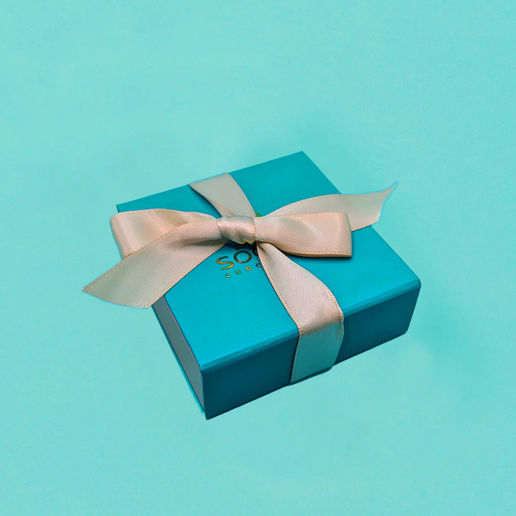 Closed four-piece Socola chocolate gift box tied with ivory ribbon